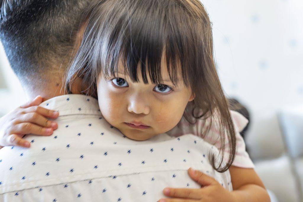 Grieving daughter is comforted by her father