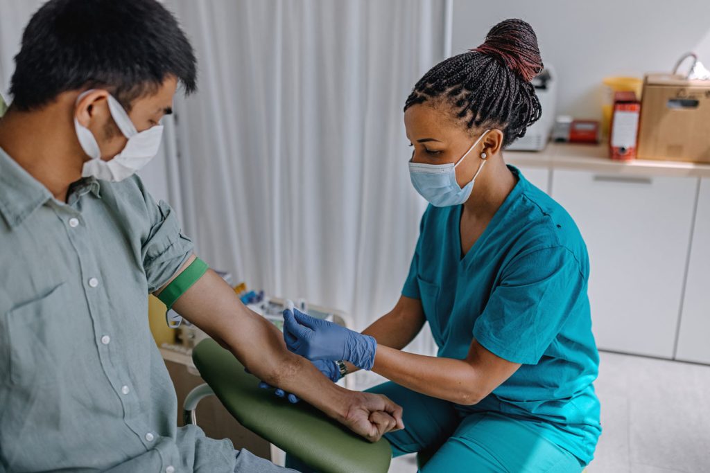 Man donating blood on Blood Donor Month