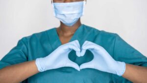 Nurse making a heart sign with her hands