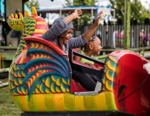 children riding a carnival ride