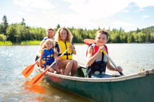 Family paddling a canoe in a lake