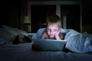 child on computer late at night