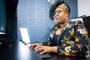 woman at computer with a uv light